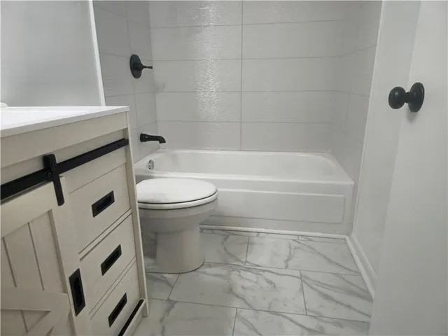 a kitchen with a sink cabinets and a refrigerator