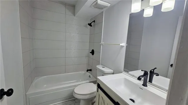 a view of a livingroom with a ceiling fan and window