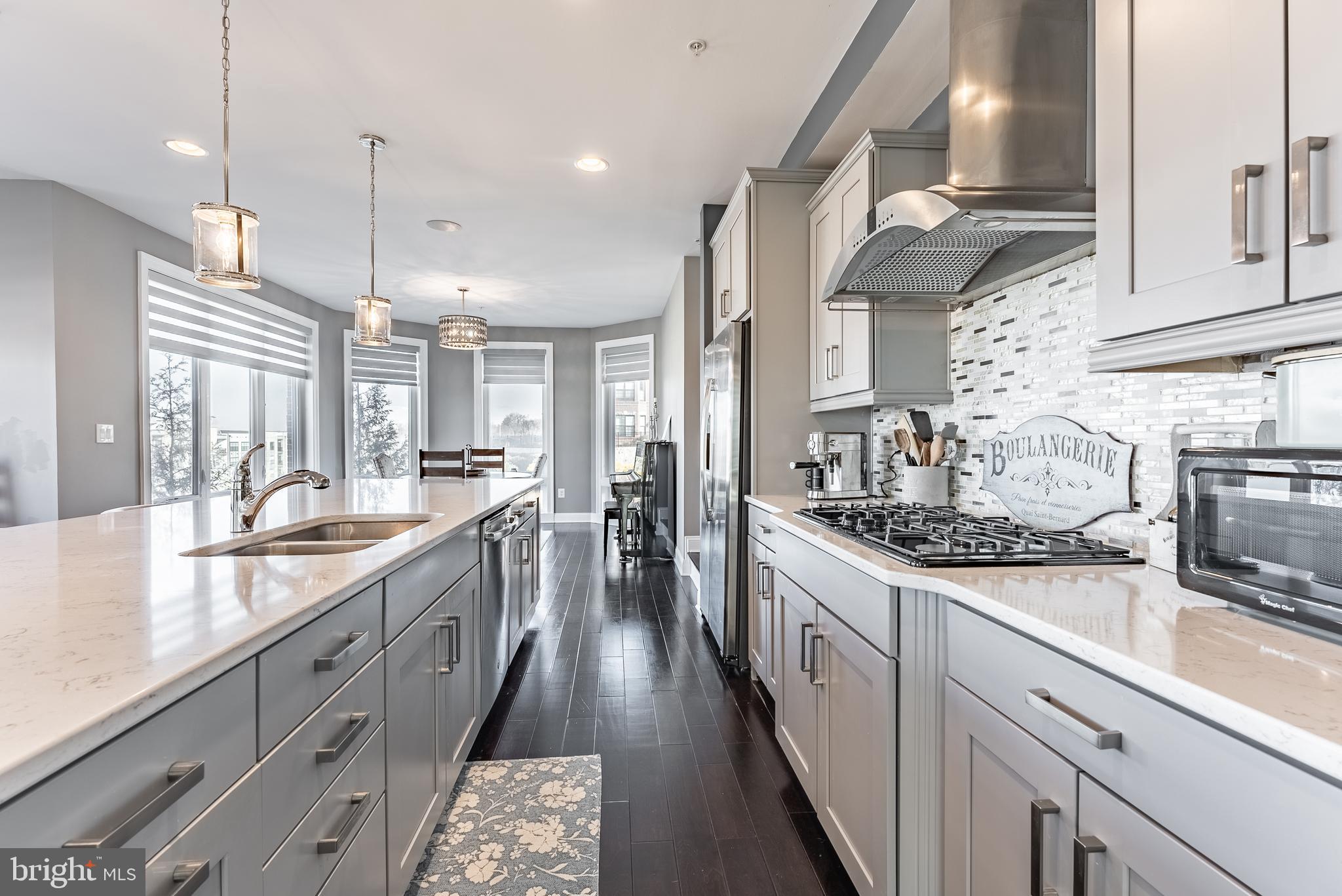 500 Riversail Lane, Unit 438 Oxon Hill, MD 20745 - Photo 13 of 54 a large kitchen with stainless steel appliances granite countertop a lot of counter space and wooden floors