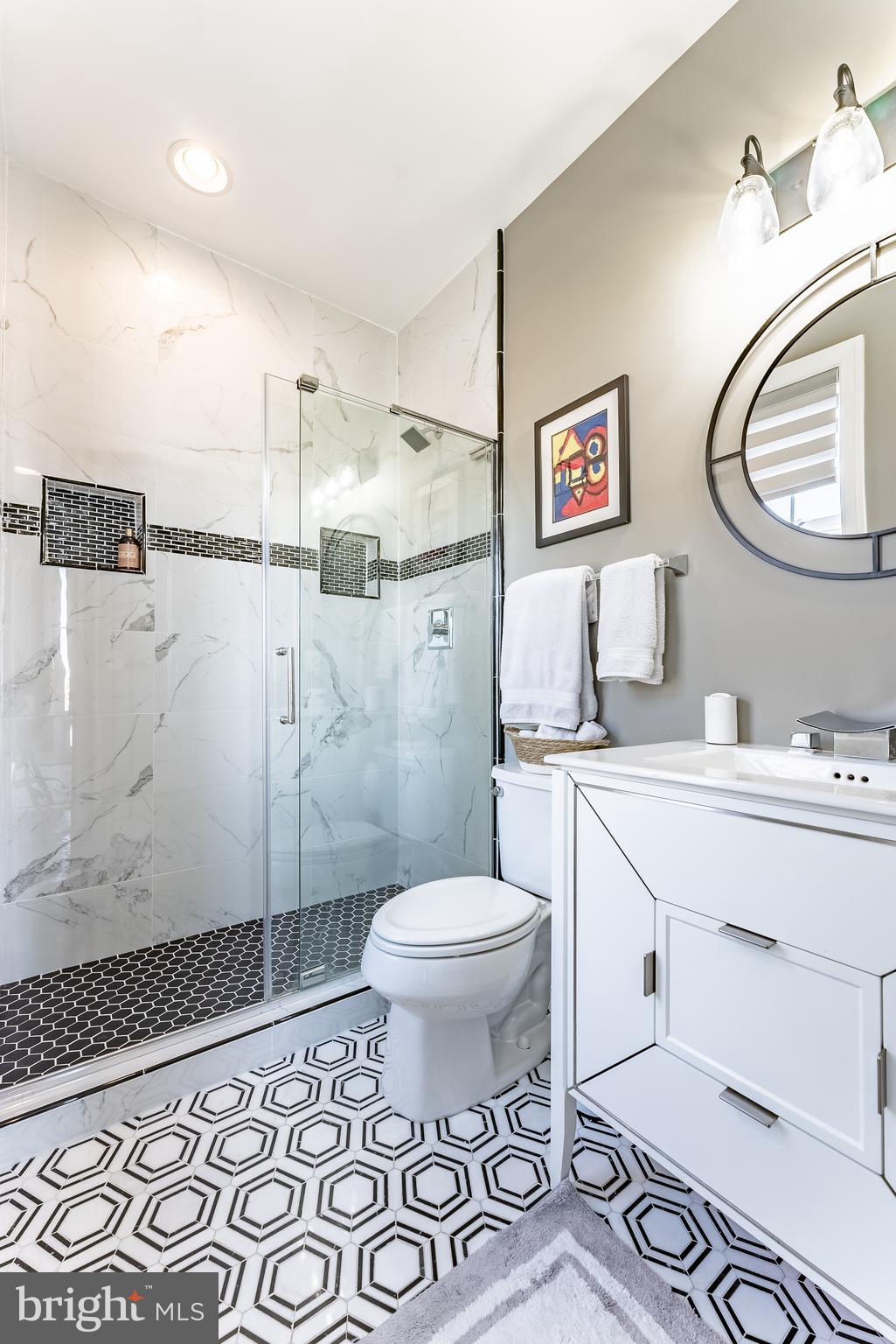 500 Riversail Lane, Unit 438 Oxon Hill, MD 20745 - Photo 17 of 54 a bathroom with a sink toilet and a mirror