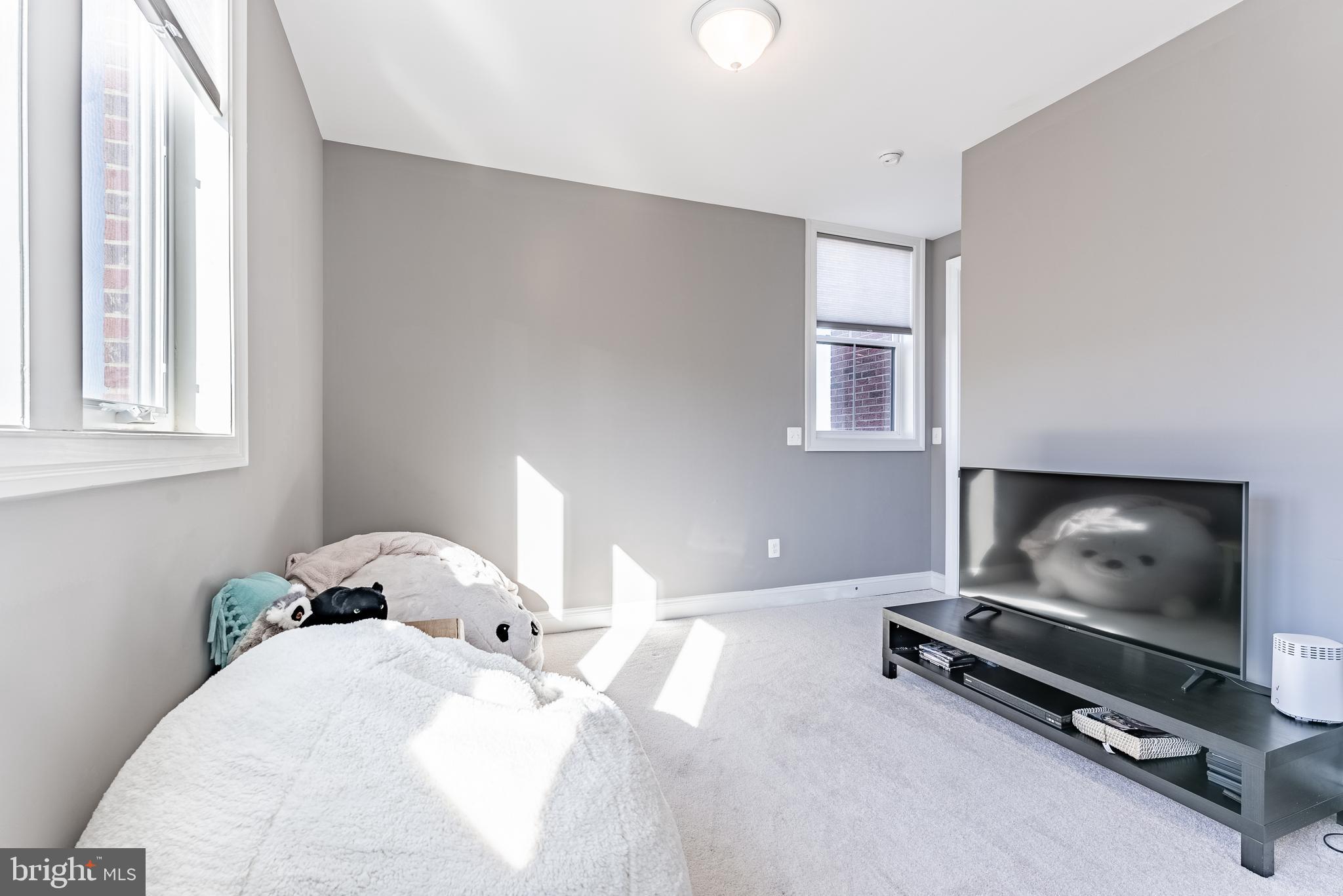 500 Riversail Lane, Unit 438 Oxon Hill, MD 20745 - Photo 31 of 54 a bedroom with a bed and flat screen tv