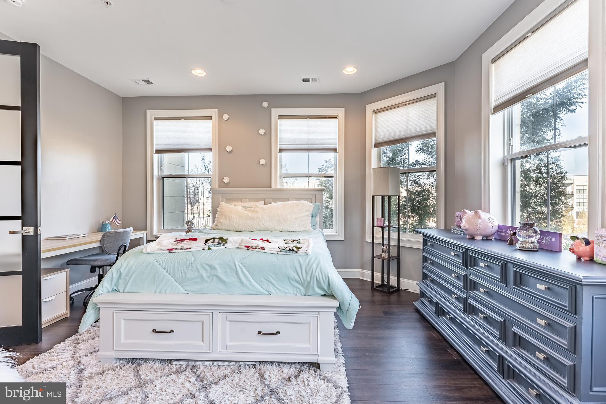 500 Riversail Lane, Unit 438 Oxon Hill, MD 20745 - Photo 9 of 54 a bedroom with a bed and large windows