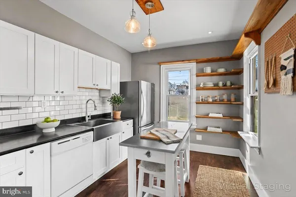a kitchen with stainless steel appliances granite countertop a sink a stove and cabinets
