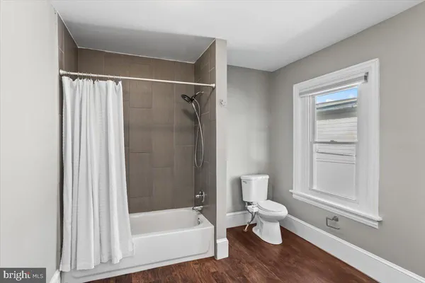 a bathroom with a sink and mirror with toilet