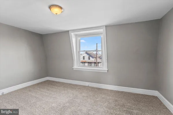 a view of an empty room and a window