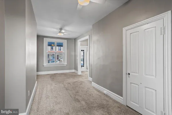 an empty room with windows and closet