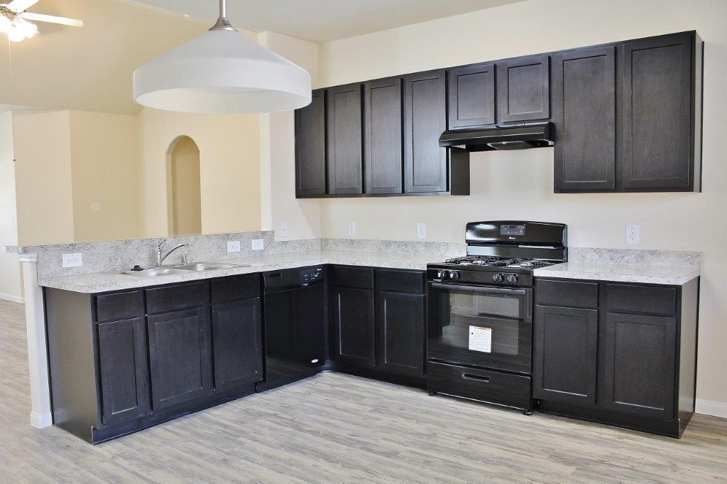 12243 Roy Mix Bohn Lane Houston, TX 77044 - Photo 13 of 16 a kitchen with stainless steel appliances granite countertop a refrigerator and a stove