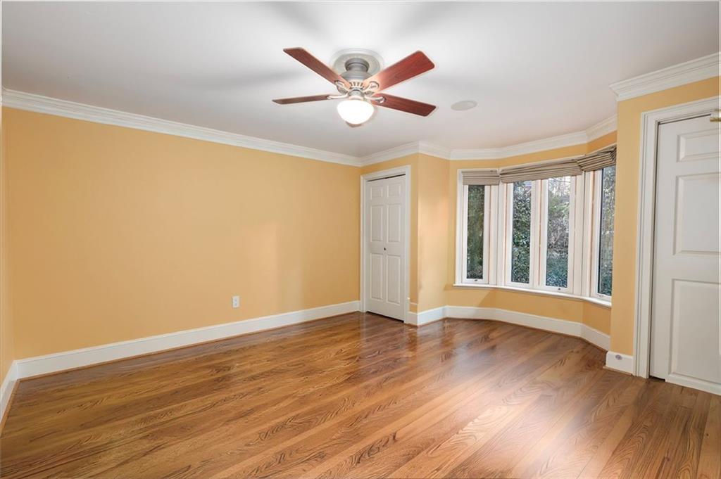 2010 Carrington Court Smoke Rise, GA 30087 - Photo 11 of 56 a view of an empty room with wooden floor and a window