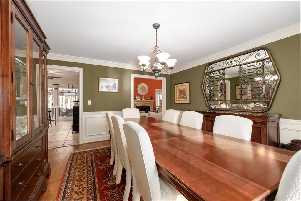 2010 Carrington Court Smoke Rise, GA 30087 - Photo 13 of 56 a view of a dining room with furniture a chandelier and wooden floor