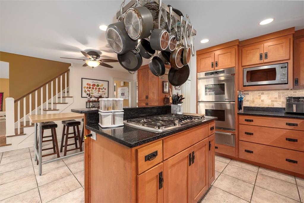 2010 Carrington Court Smoke Rise, GA 30087 - Photo 15 of 56 a kitchen with stainless steel appliances granite countertop a stove a sink dishwasher and a microwave