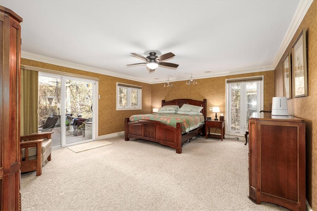 2010 Carrington Court Smoke Rise, GA 30087 - Photo 17 of 56 a spacious bedroom with a bed and wooden floor