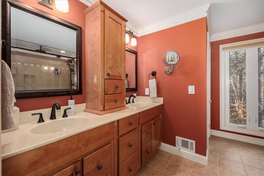 2010 Carrington Court Smoke Rise, GA 30087 - Photo 19 of 56 a bathroom with a double vanity sink and a mirror