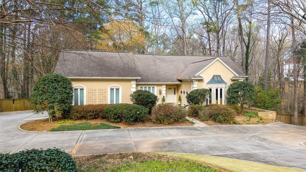 2010 Carrington Court Smoke Rise, GA 30087 - Photo 3 of 56 a front view of house with yard and trees around