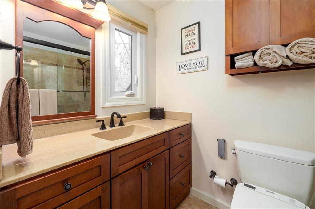 2010 Carrington Court Smoke Rise, GA 30087 - Photo 31 of 56 a bathroom with a sink a toilet and a window