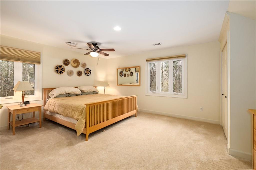2010 Carrington Court Smoke Rise, GA 30087 - Photo 32 of 56 a bedroom with a bed dresser and window
