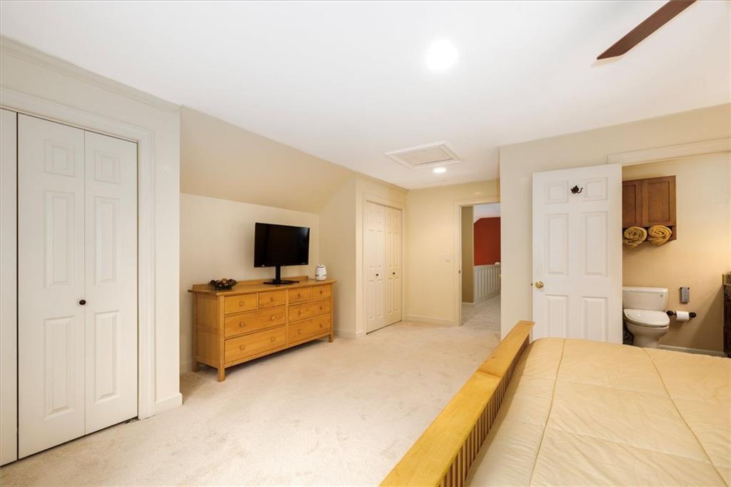 2010 Carrington Court Smoke Rise, GA 30087 - Photo 33 of 56 a spacious bedroom with a bed and a flat screen tv