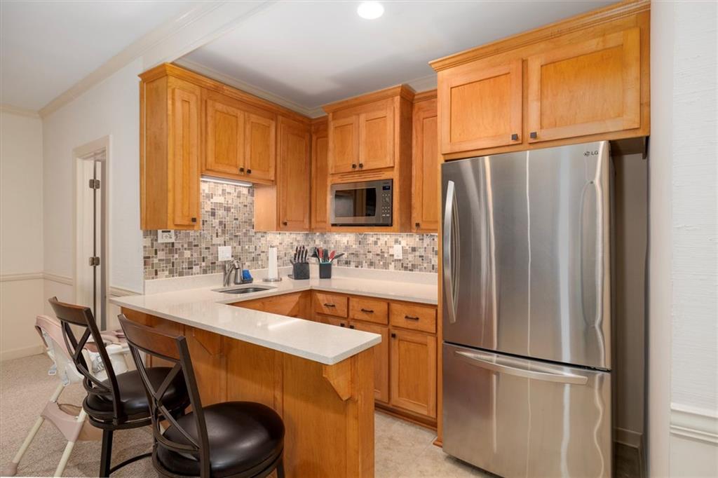 2010 Carrington Court Smoke Rise, GA 30087 - Photo 39 of 56 a kitchen with stainless steel appliances granite countertop a refrigerator and a stove top oven