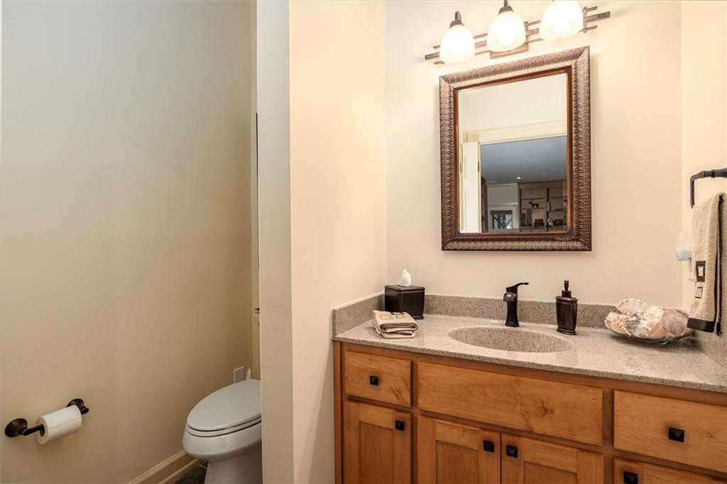 2010 Carrington Court Smoke Rise, GA 30087 - Photo 40 of 56 a bathroom with a toilet sink and mirror