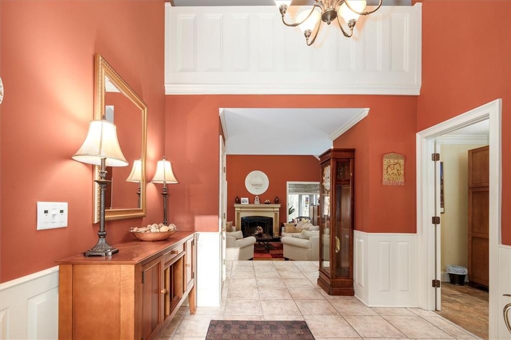 2010 Carrington Court Smoke Rise, GA 30087 - Photo 5 of 56 a living room with furniture a fireplace and a chandelier