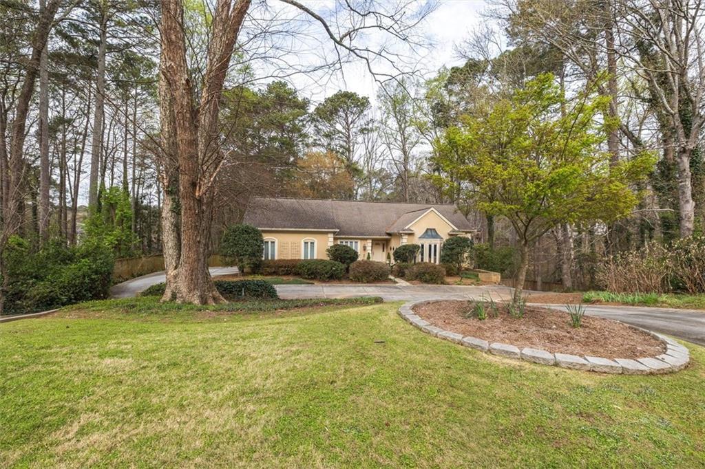 2010 Carrington Court Smoke Rise, GA 30087 - Photo 51 of 56 a view of a house with a yard and sitting area