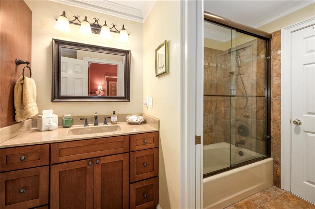 2010 Carrington Court Smoke Rise, GA 30087 - Photo 10 of 56 a bathroom with a tub a sink and mirror