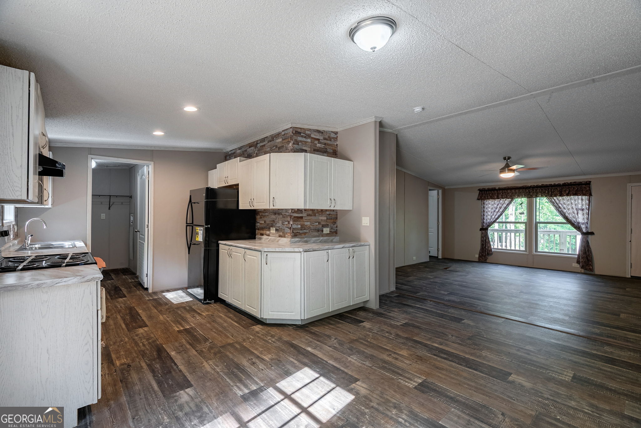 128 Sunfish Trail Southwest Eatonton, GA 31024 - Photo 12 of 48 a kitchen with a sink and wooden floor