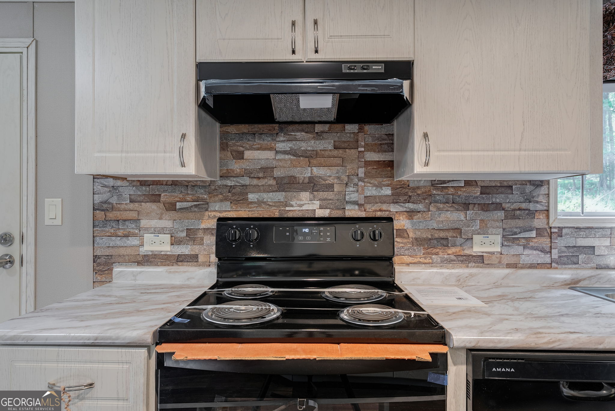128 Sunfish Trail Southwest Eatonton, GA 31024 - Photo 17 of 48 a stove top oven sitting inside of a kitchen