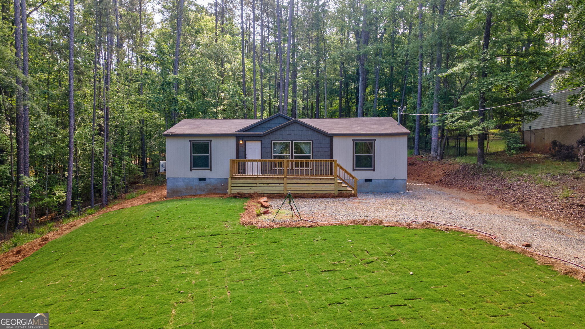 128 Sunfish Trail Southwest Eatonton, GA 31024 - Photo 2 of 48 a front view of a house with a yard table and chairs