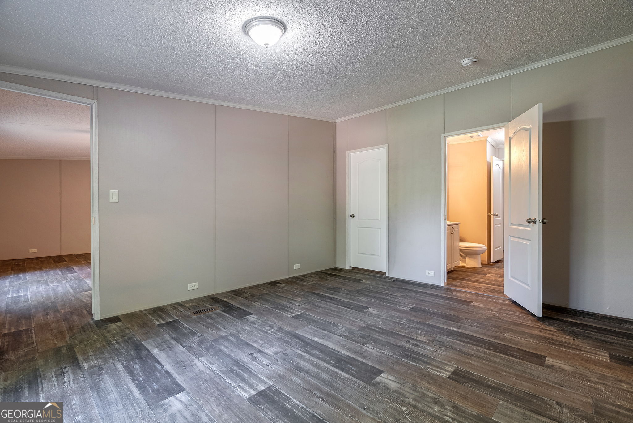 128 Sunfish Trail Southwest Eatonton, GA 31024 - Photo 22 of 48 a view of an empty room with wooden floor and a window