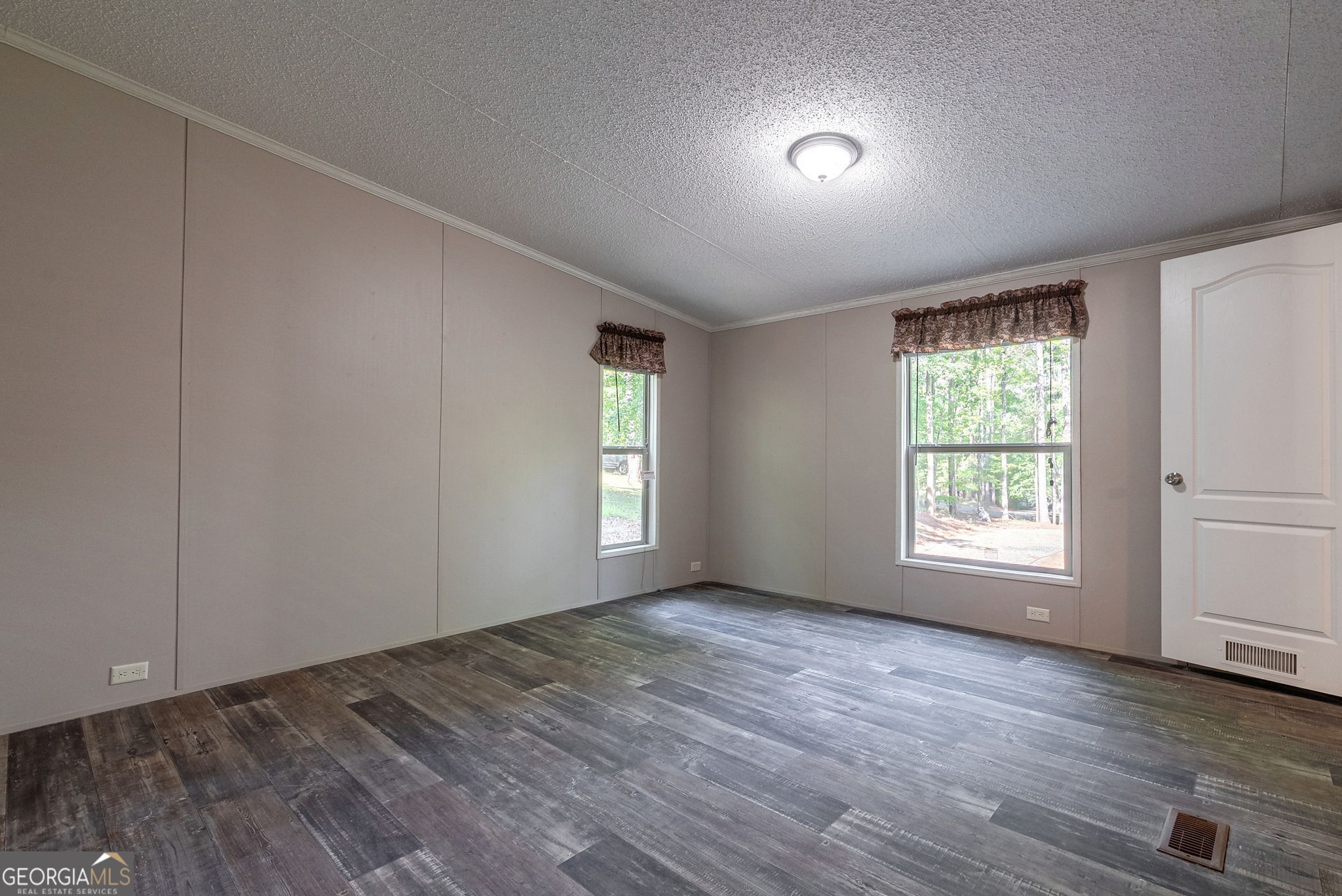 128 Sunfish Trail Southwest Eatonton, GA 31024 - Photo 23 of 48 a view of an empty room with wooden floor and window