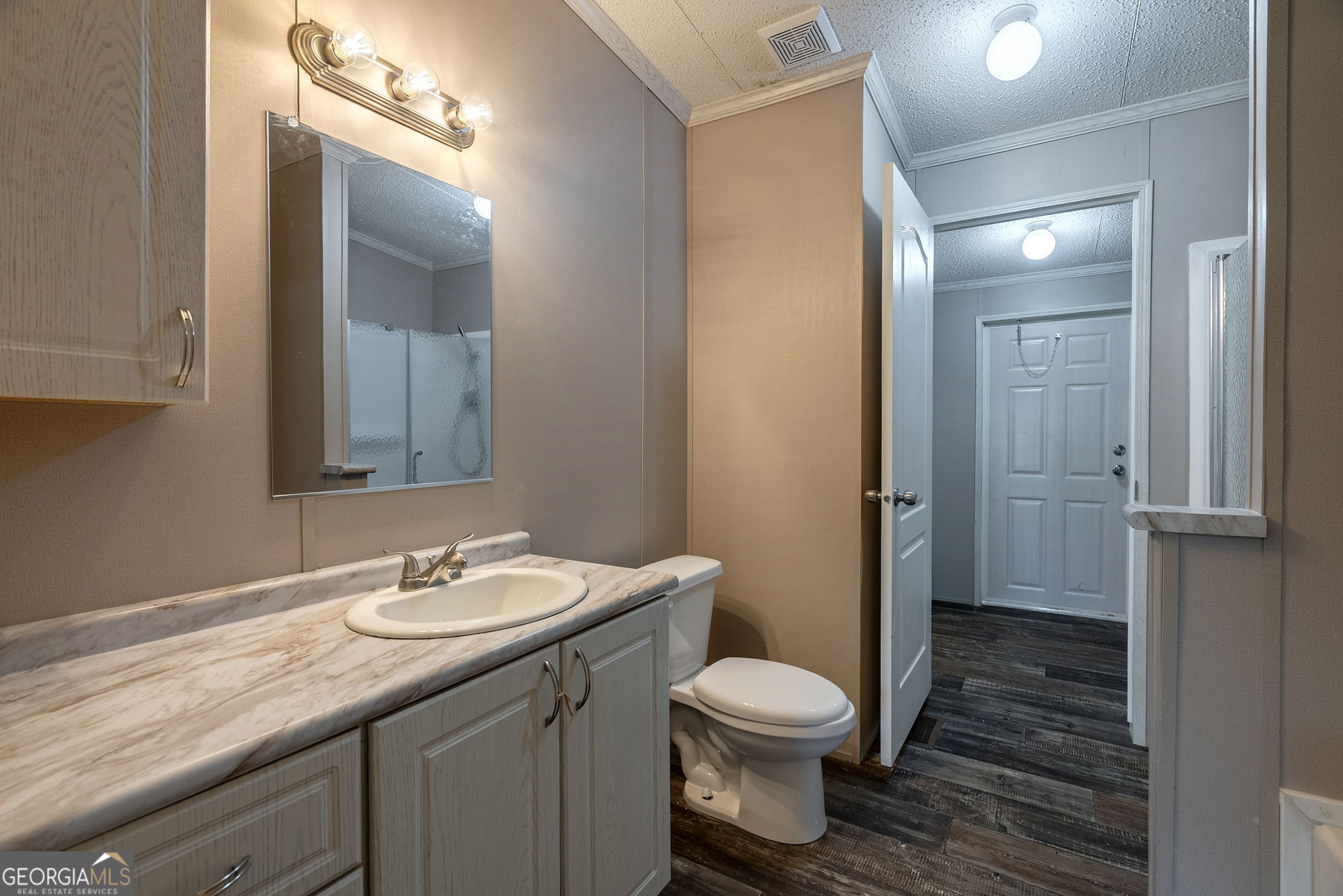 128 Sunfish Trail Southwest Eatonton, GA 31024 - Photo 25 of 48 a bathroom with a granite countertop sink toilet and shower