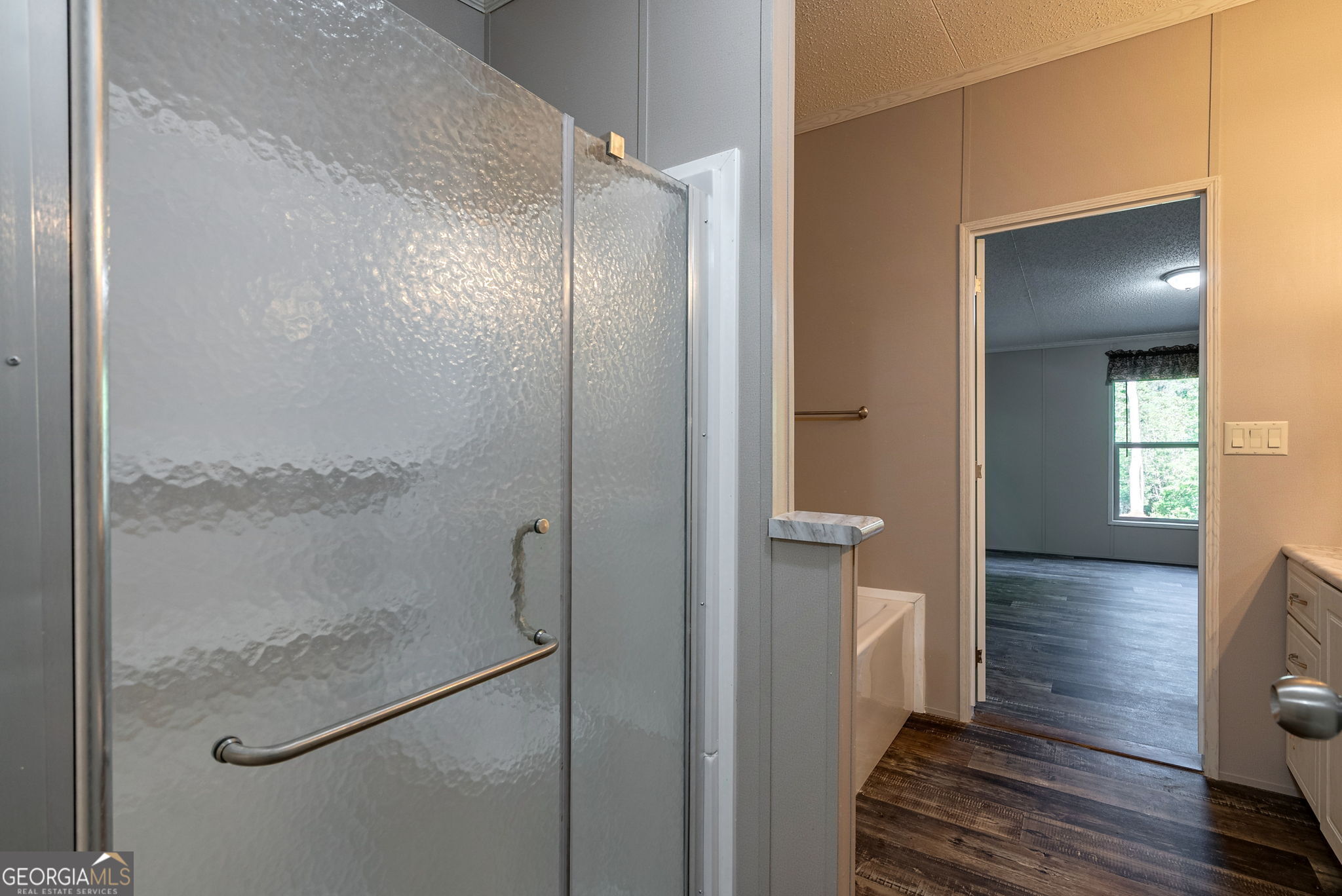 128 Sunfish Trail Southwest Eatonton, GA 31024 - Photo 26 of 48 a bathroom with a glass shower door