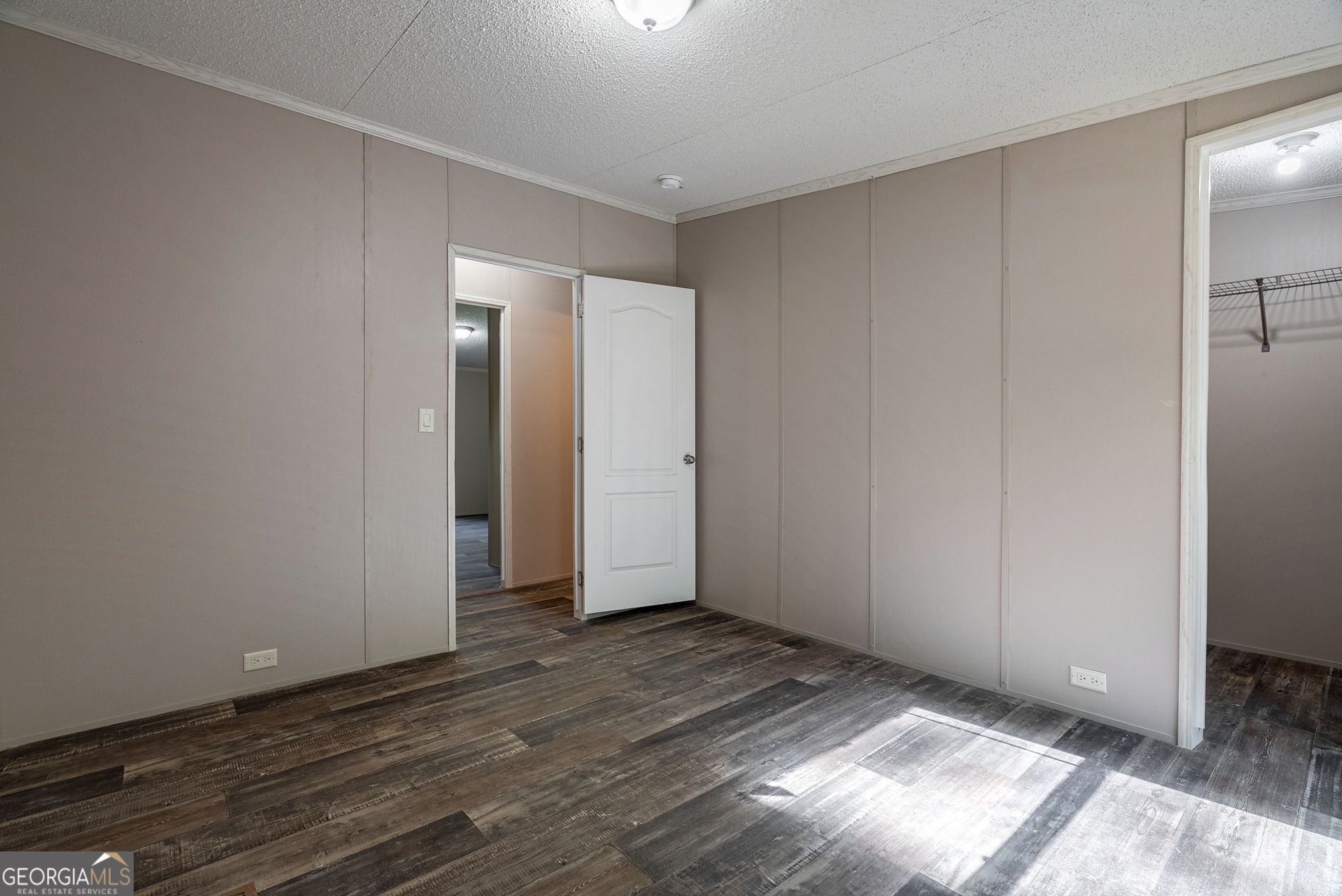 128 Sunfish Trail Southwest Eatonton, GA 31024 - Photo 29 of 48 an empty room with wooden floor and windows