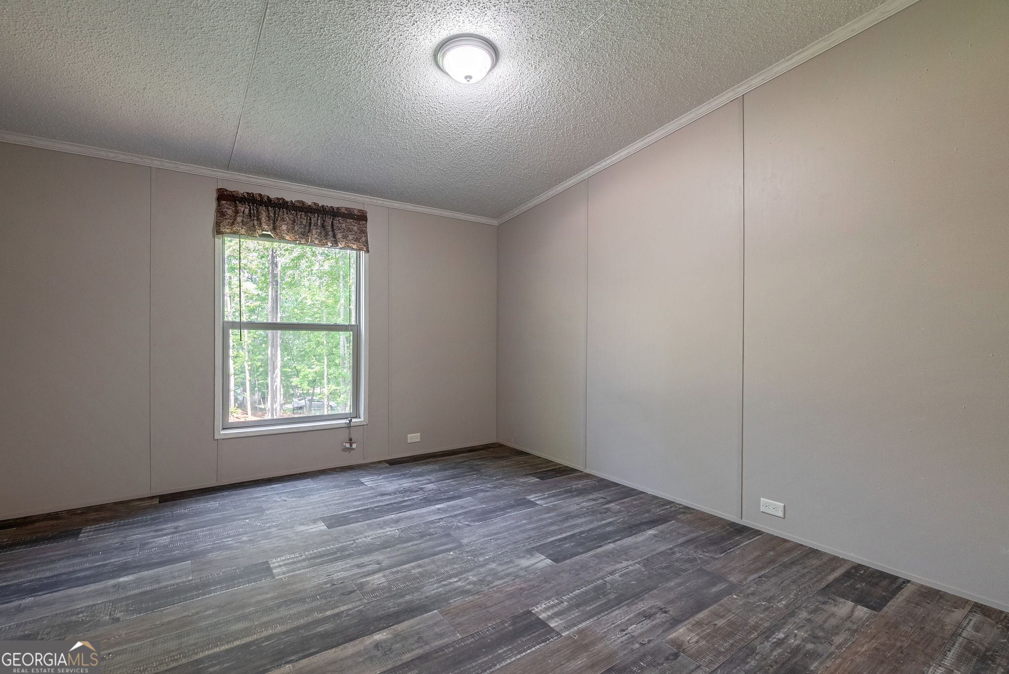 128 Sunfish Trail Southwest Eatonton, GA 31024 - Photo 31 of 48 an empty room with wooden floor and windows