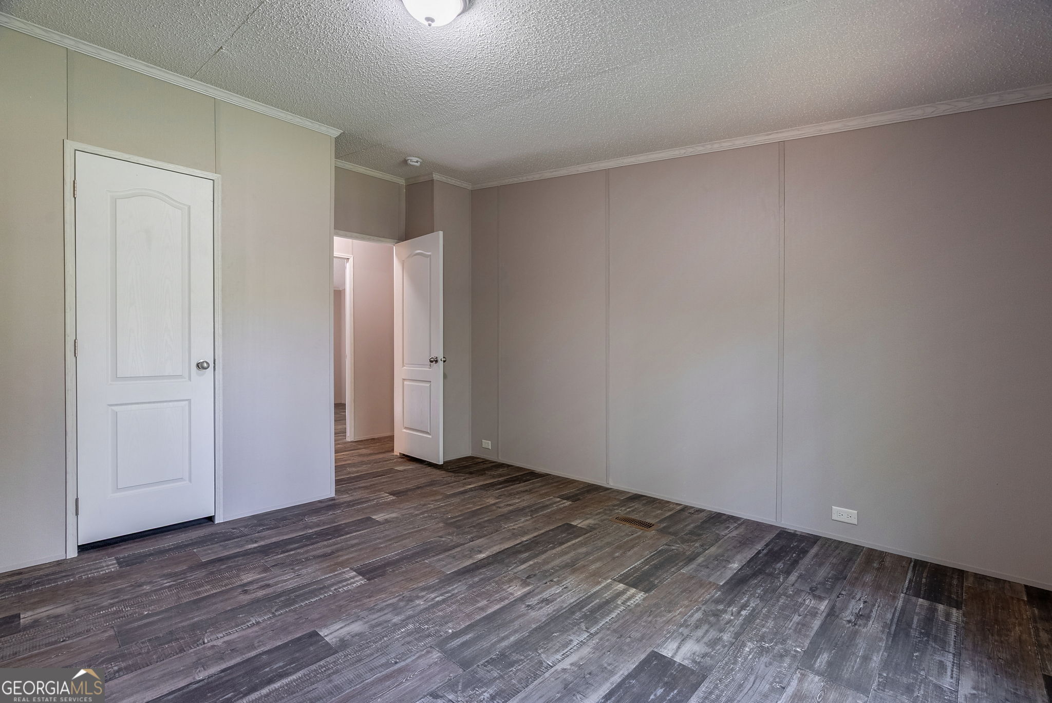 128 Sunfish Trail Southwest Eatonton, GA 31024 - Photo 32 of 48 a view of an empty room with wooden floor and closet
