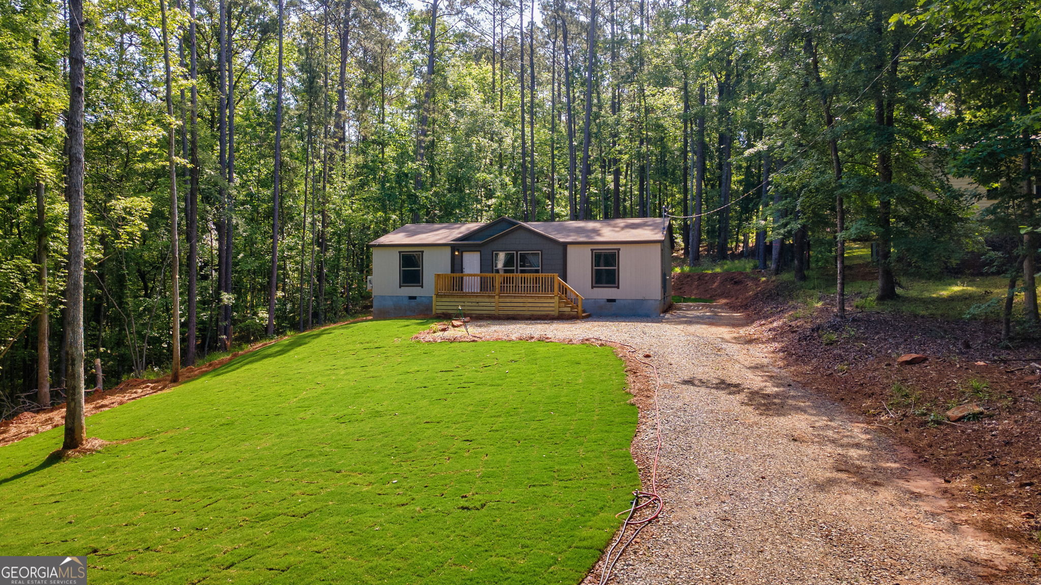 128 Sunfish Trail Southwest Eatonton, GA 31024 - Photo 44 of 48 a view of a house with backyard and a tree