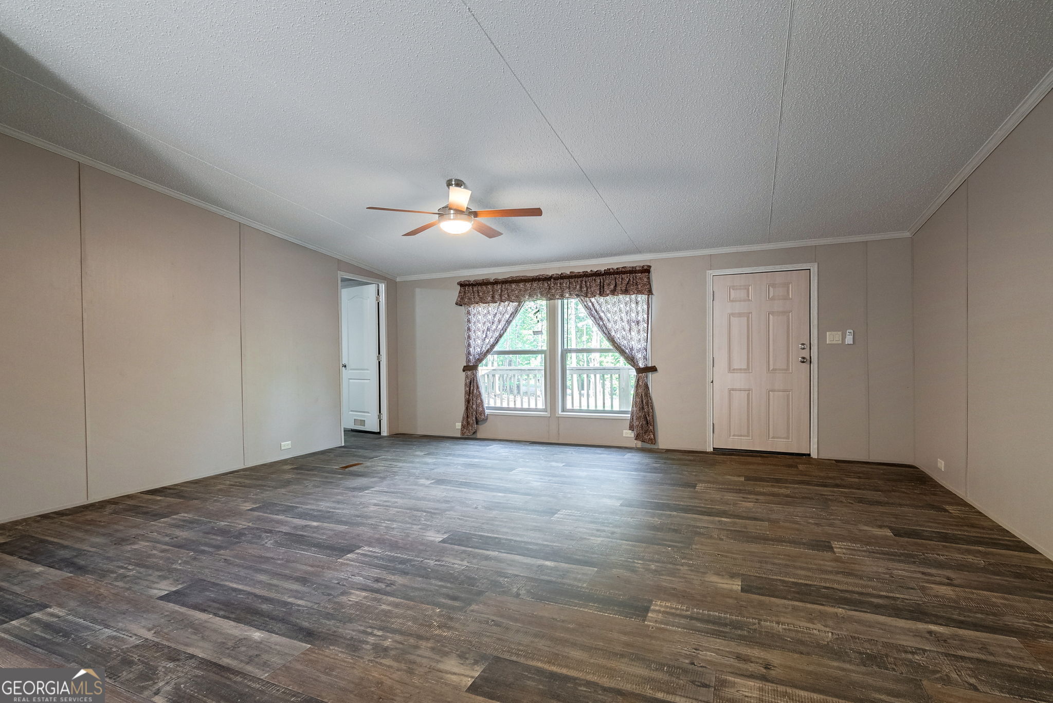 128 Sunfish Trail Southwest Eatonton, GA 31024 - Photo 8 of 48 a view of an empty room with a window