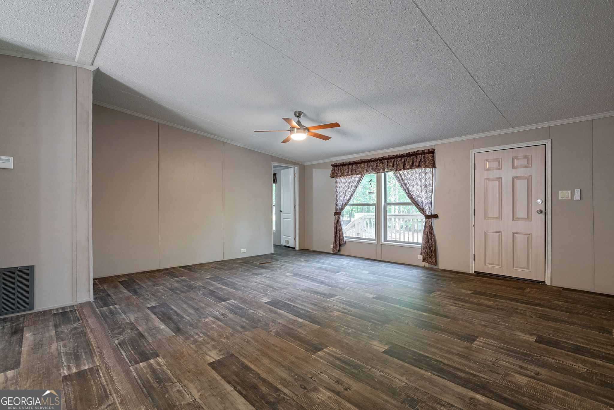 128 Sunfish Trail Southwest Eatonton, GA 31024 - Photo 9 of 48 a view of empty room with wooden floor and fan