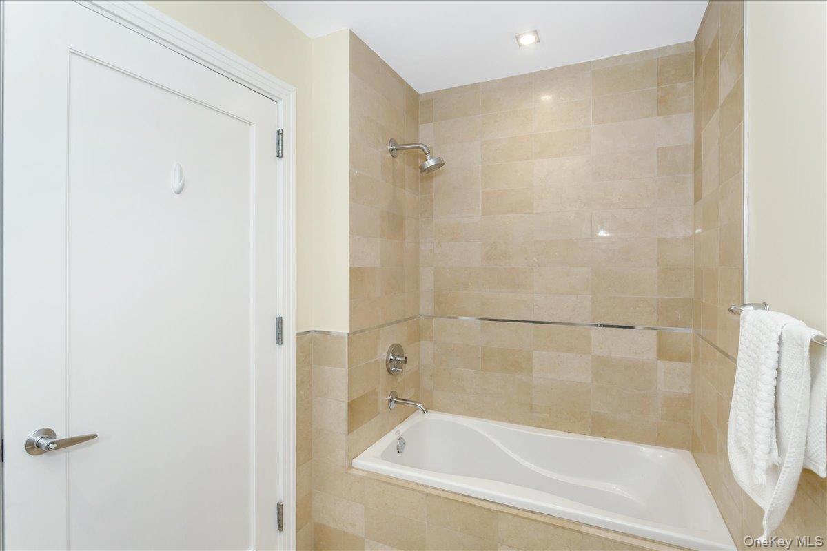 64-05 Yellowstone Boulevard, Unit 207 Queens, NY 11375 - Photo 14 of 18 a bathroom with a bathtub