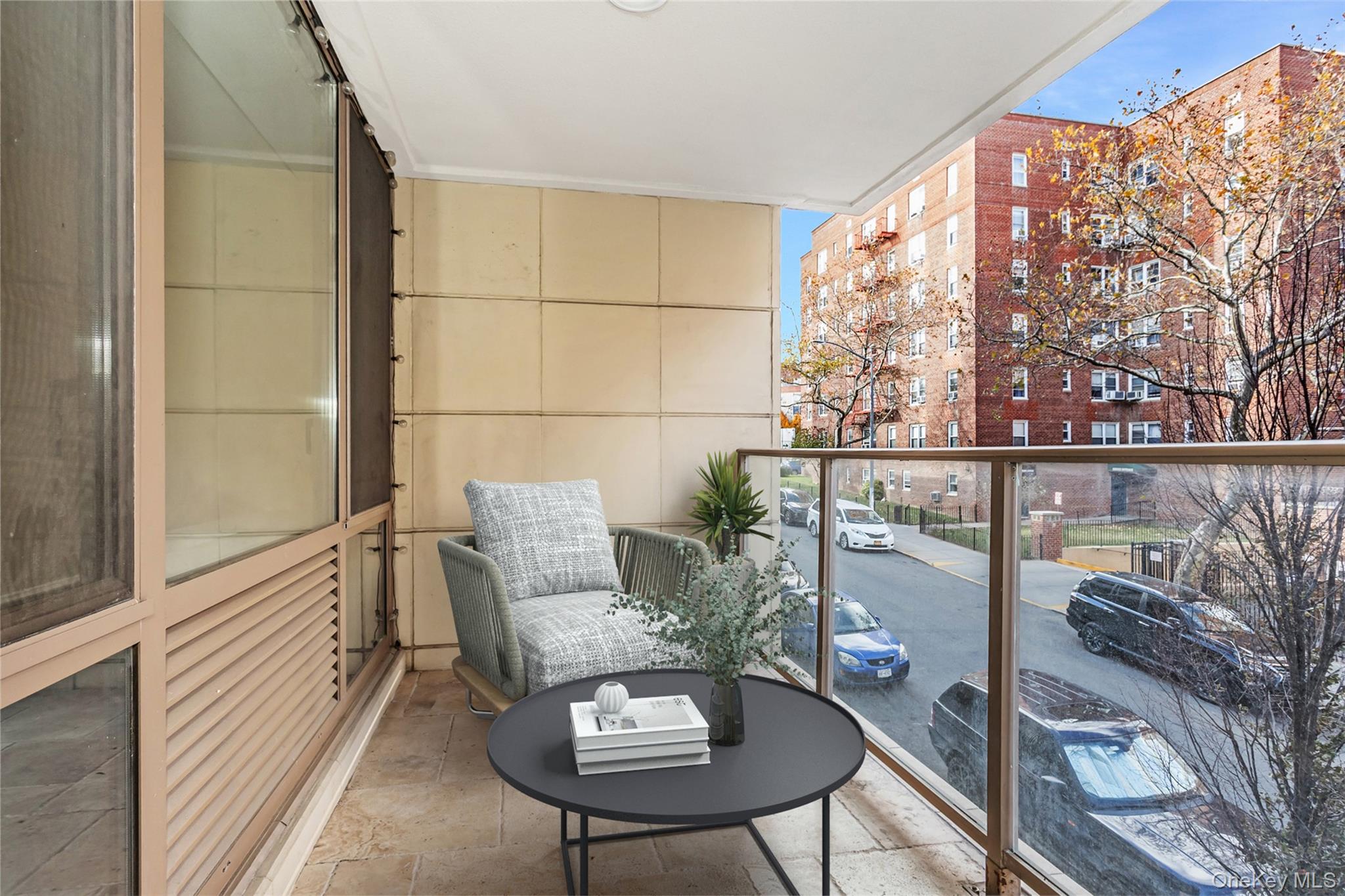 64-05 Yellowstone Boulevard, Unit 207 Queens, NY 11375 - Photo 8 of 18 a balcony with furniture and wooden floor