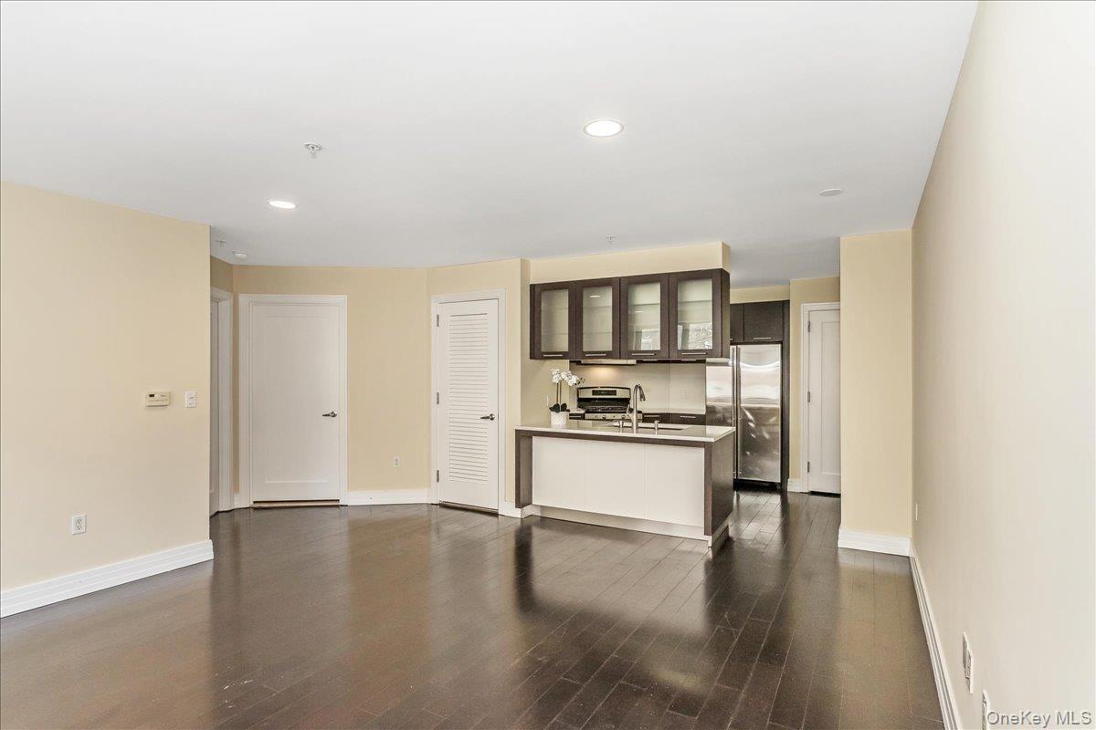 64-05 Yellowstone Boulevard, Unit 207 Queens, NY 11375 - Photo 10 of 18 a kitchen with a sink cabinets and wooden floor