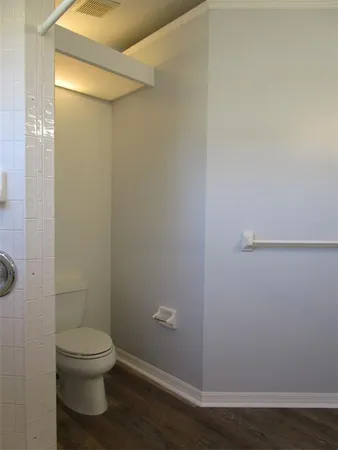 a bathroom with a toilet and a shower