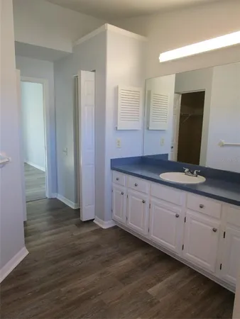a spacious bathroom with double vanity and mirrors