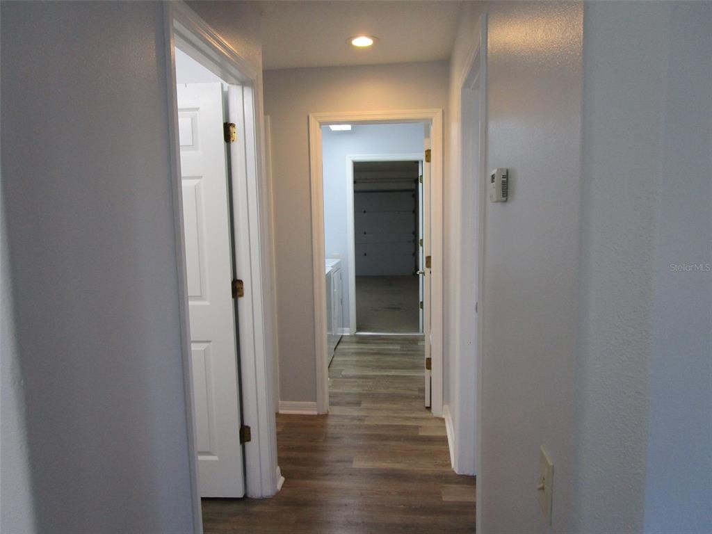 8826 Kilmer Way Hudson, FL 34667 - Photo 22 of 36 a view of a hallway with wooden floor