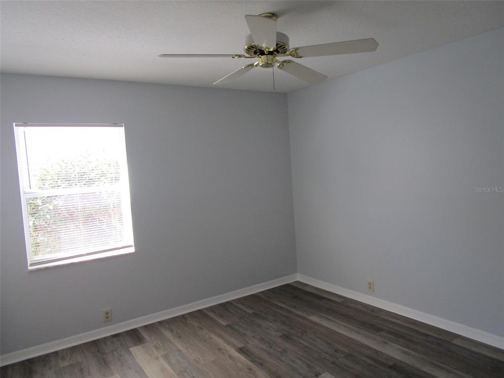 8826 Kilmer Way Hudson, FL 34667 - Photo 26 of 36 an empty room with a window and a fan