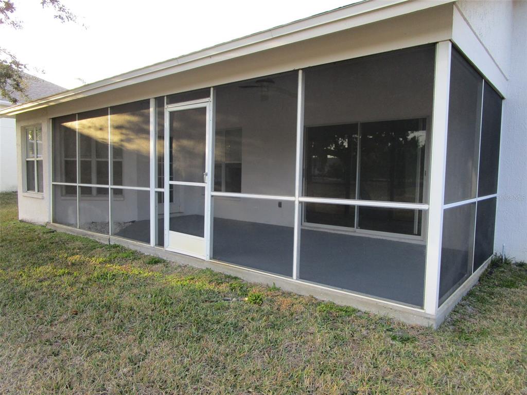8826 Kilmer Way Hudson, FL 34667 - Photo 34 of 36 a view of an empty room with wooden floor and a window