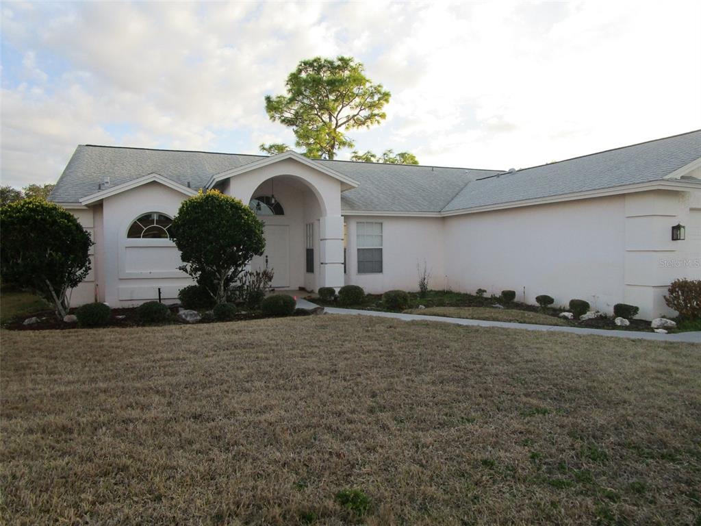 8826 Kilmer Way Hudson, FL 34667 - Photo 36 of 36 a front view of a house with garden