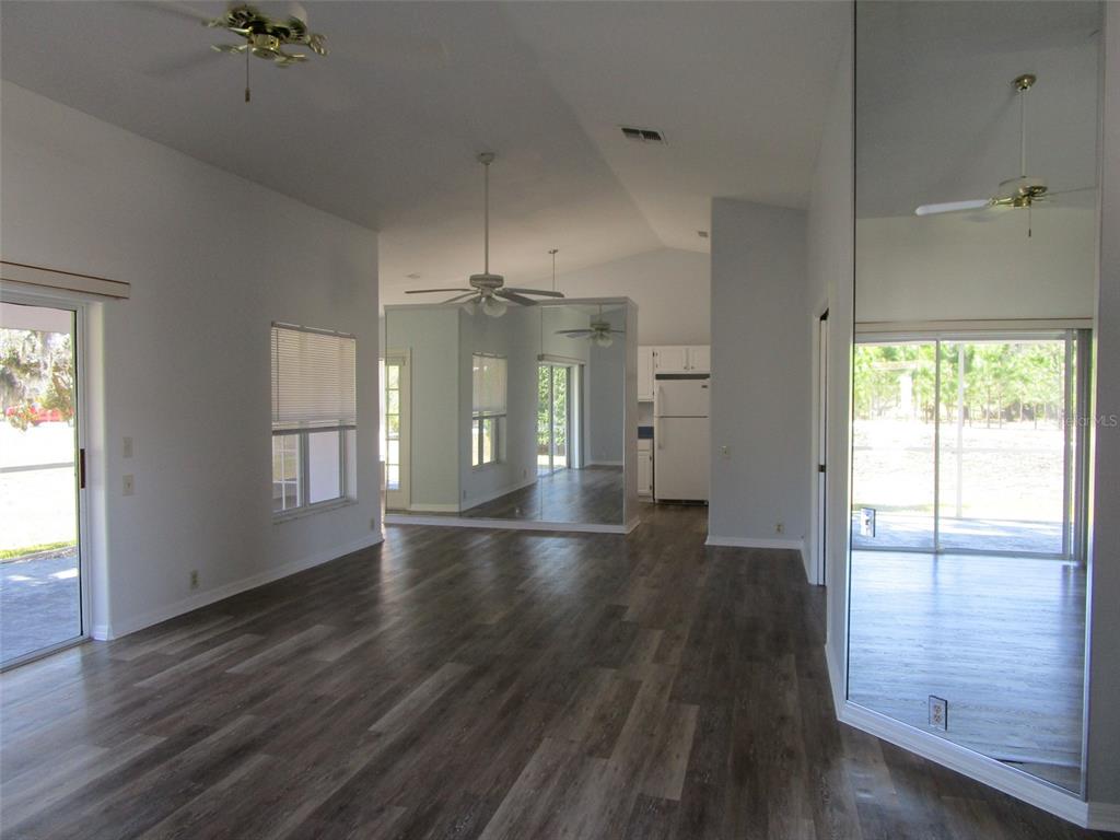 8826 Kilmer Way Hudson, FL 34667 - Photo 4 of 36 an empty room with wooden floor and windows