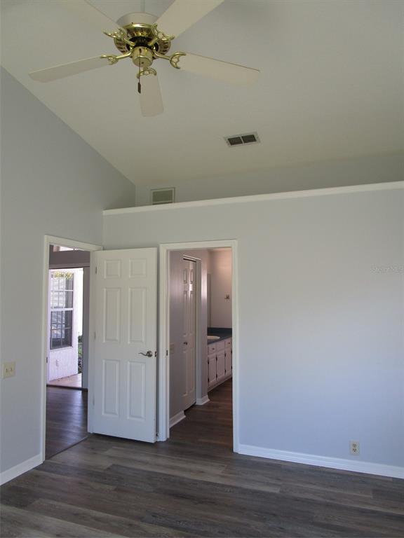 8826 Kilmer Way Hudson, FL 34667 - Photo 7 of 36 a view of a hallway with wooden floor and chandelier