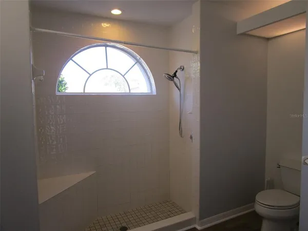 a view of bathroom with a toilet and a window